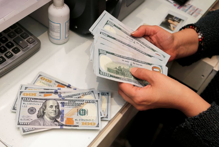 “Dollar to stay strong this year, weaken next, Reuters analyst poll shows”